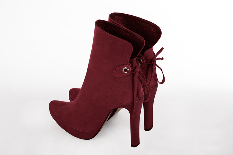 Burgundy red women's ankle boots with laces at the back. Tapered toe. Very high slim heel with a platform at the front. Rear view - Florence KOOIJMAN